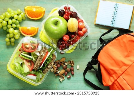 healthy food school lunch box with fruits vegetables and sandwich