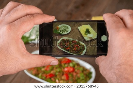 Smartphone photo of food.Mans hands make phone photography of Oriental traditional meals. lunch or dinner. For social media, blogging.  Healthy food