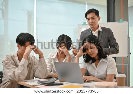 A serious and professional Asian male boss is complaining about the failed project and unprofessional work performance of his employees in the meeting. Royalty-Free Stock Photo #2315773985