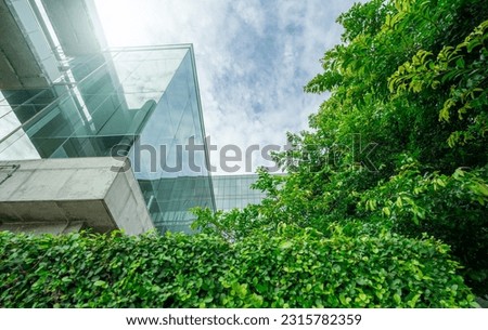 Sustainble green building. Eco-friendly building in modern city. Sustainable glass office building with tree for reducing carbon dioxide. Office with green environment. Corporate building reduce CO2. Royalty-Free Stock Photo #2315782359