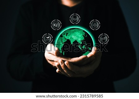 human are raising the planet to save energy,and reduce global warming,idea for environment conscious business,carbon credit,reducing greenhouse gas emissions,ESG for Environment Social and Governance Royalty-Free Stock Photo #2315789585