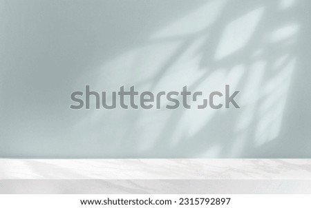 Abstract minimalistic universal background for product presentation with shadow on light blue wall and marble top.