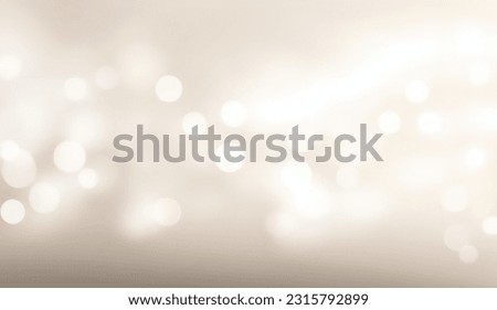 Abstract blurred light beige background with soft bokeh from lights.