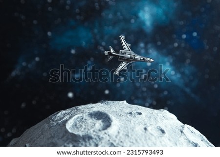 Toy plane flies near the moon, starry background. The concept of space tourism development.