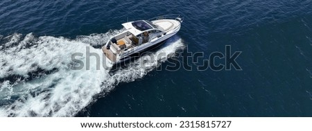 Aerial drone ultra wide photo of small speed boat with dual outboards cruising in high speed deep blue Aegean sea Royalty-Free Stock Photo #2315815727