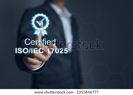 A businessman pointing on certified mark of ISO IEC 17025, which is the standard of international quality association laboratory accreditations management system. Royalty-Free Stock Photo #2315846777