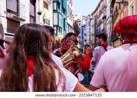 People doused with wine celebrate San Fermin festival in traditional white abd red clothing with red necktie in Pamplona, Navarra, Spain Royalty-Free Stock Photo #2315847135