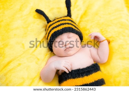Asian Baby Girl dress in a bee costume,baby in bee costume,newborn baby in bee costume. newborn baby concept shot