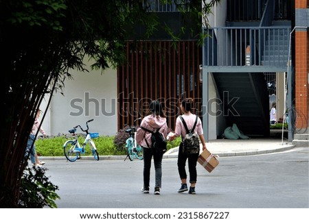 Photos of college students walking in the campus, the colorful campus life in a Chinese college.