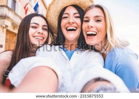 Three best friends taking selfie picture with smartphone outdoors on city street- Young group of tourist girls having fun on holiday and enjoying summer -Friendship Vacation concept with youth people