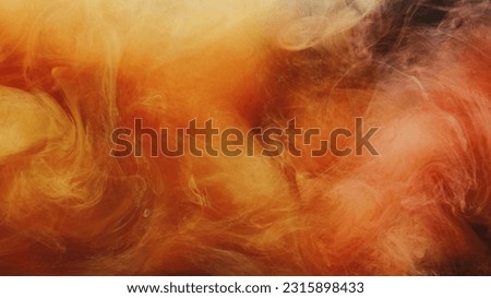 Color vapor splash. Ink water. Fire flame explosion. Yellow orange red fume cloud texture on black abstract art background.