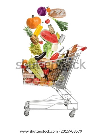 Market assortment. Different products falling into shopping cart on white background Royalty-Free Stock Photo #2315903579