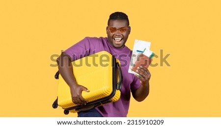 Summer Vacation Offer. Joyful Black Tourist Man With Suitcase Showing His Travel Tickets And Map, Posing Wearing Sunglasses On Yellow Studio Background. Portrait Of Traveler. Panorama