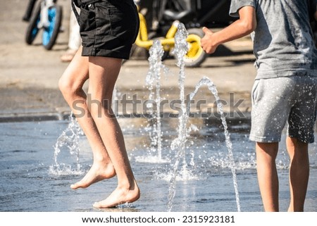 
Children play with water in fountains on a hot summer street, selective focus. Very hot weather in the Netherlands. Cooling with water in the heat in the city.
 Royalty-Free Stock Photo #2315923181