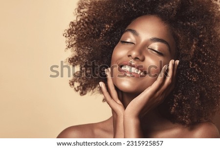 Beauty portrait of african american woman with clean healthy skin on beige background. Smiling dreamy beautiful afro girl.Curly black hair Royalty-Free Stock Photo #2315925857
