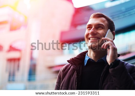 Portrait of a happy businessman walking outdoors with mobile phone. Man with phone. Happy man talking phone. Man walking with phone. Man outdoor with phone. Businessman outdoor with phone. Royalty-Free Stock Photo #231593311