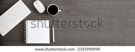 notepad with keyboard and coffee on desk
