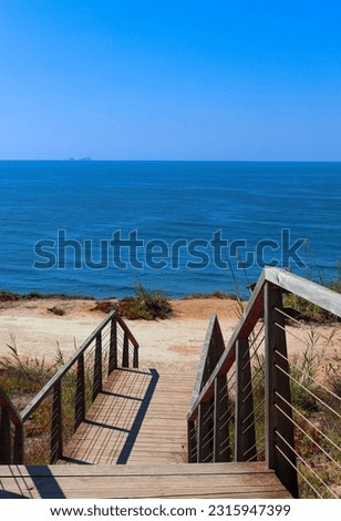 A wooden pathway leading towards the ocean. Portugal.