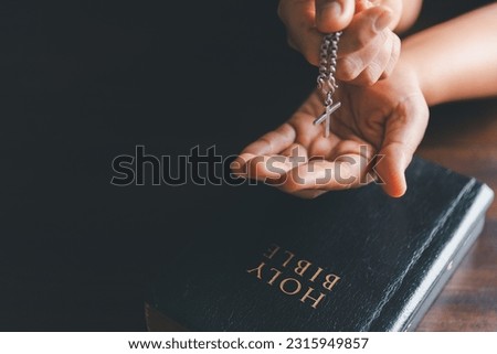 Christianity woman catholic hand holding cross crucifix pray to god, person prayer in church concept of religion, spirituality, religious, believe, faith, hope, worship.