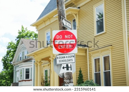 An imposing red 'Do Not Enter' sign stands tall, conveying a powerful message of restriction, danger, and the need to respect boundaries Royalty-Free Stock Photo #2315960141