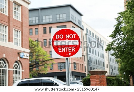 An imposing red 'Do Not Enter' sign stands tall, conveying a powerful message of restriction, danger, and the need to respect boundaries