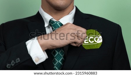 Eco-friendly corporate promoting sustainable and green business concept with businessman hold ECO symbol paper as environmental protection commitment using clean energy with zero CO2 emission. Alter