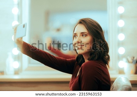 
Woman Taking a Selfie at the Hairdresser Salon. Pretty girl having a new look taking a self portrait 
