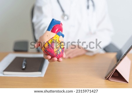 Doctor with human Heart anatomy model and tablet. Cardiovascular Diseases, Atherosclerosis, Hypertensive Heart, Valvular Heart, Aortopulmonary window, world Heart day and health concept Royalty-Free Stock Photo #2315971427