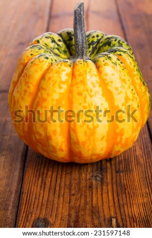Yellow pumpkin on wooden table 