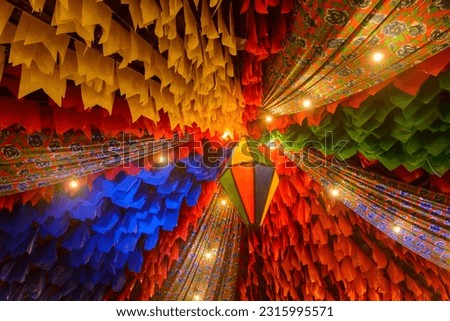Colorful flags and a balloon, decoration for the Saint John  festival, which takes place in June in the Northeast of Brazil. Royalty-Free Stock Photo #2315995571