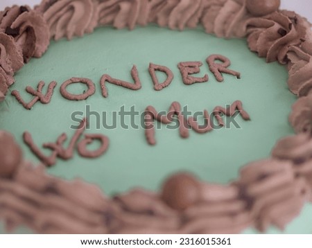 frosted icing elegant cake with funny lettering topping. Mother s day celebration cupcake. Humor in food concept. Family love. Royalty-Free Stock Photo #2316015361