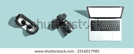 Tech gear theme with vr headset, dslr camera and laptop computer
