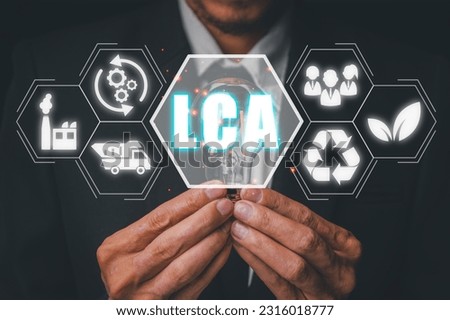 LCA, Life cycle assessment concept, Business person hand holding light bulb with Life cycle assessment icon on virtual screen.