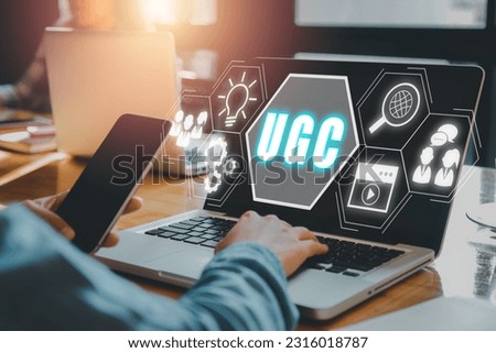 User generated content (UGC) concept, Digital marketing strategy, Person using laptop computer on desk with User generated content icon on virtual screen. Royalty-Free Stock Photo #2316018787