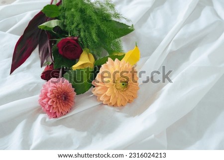 A bouquet of flowers on a white cloth.