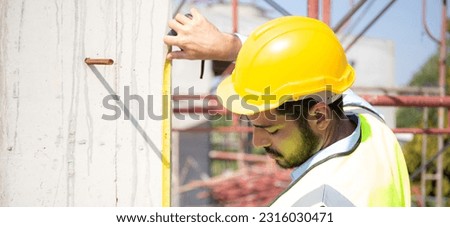 Engineer young man using tape measure for check and examining length of structure with professional at construction site, architect inspection and improvement infrastructure, industry concept.