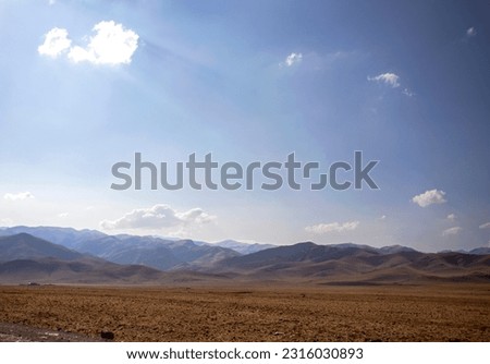 Large plain and mountain silhouettes against the sky
