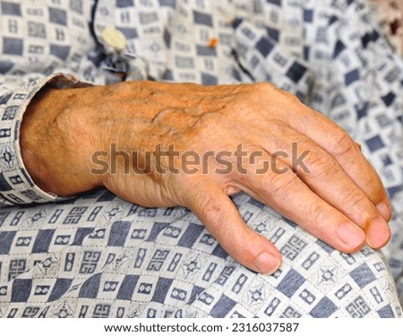 Close-up image of an elderly person's hand.