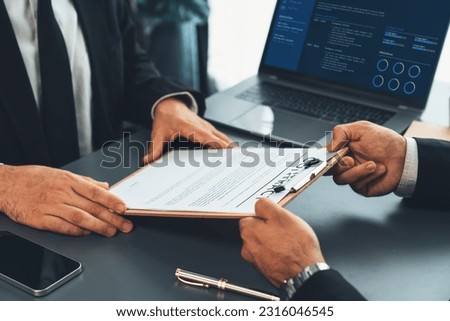 Closeup business deal meeting, businessman carefully reviewing terms and condition of contract agreement papers in office. Corporate lawyer give consultation on contract deal. Fervent