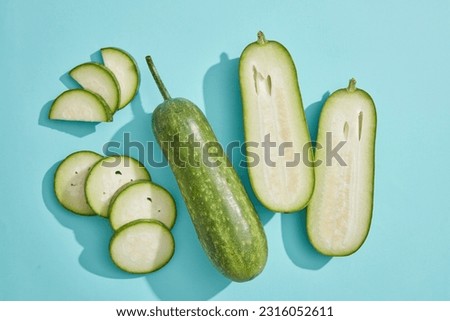 Natural fresh fruit concept with winter melon cut in half and slices over light blue background. The antioxidants in Winter melon (Benincasa hispida) help reduce oxidative stress Royalty-Free Stock Photo #2316052611