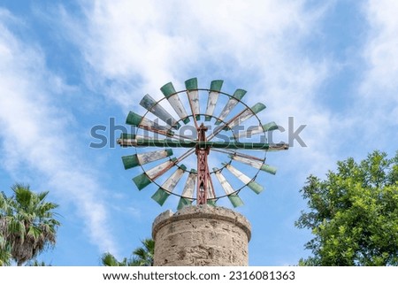 Green and white windmill typical of the island of Mallorca, Spain