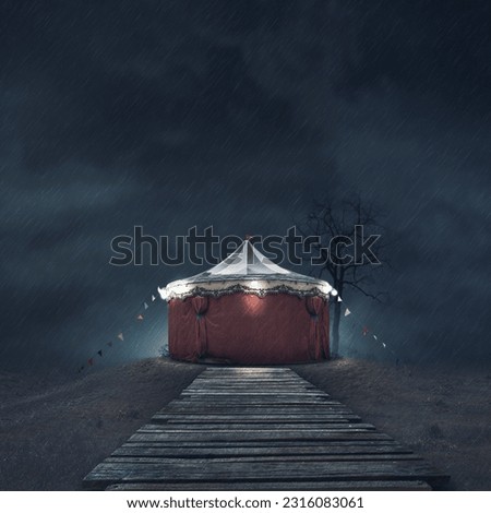 Scary vintage circus tent under the rain in the dark Royalty-Free Stock Photo #2316083061