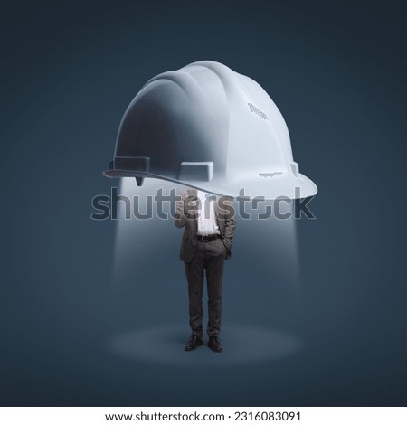 Big safety helmet protecting a corporate businessman using a smartphone: data protection, security and business Royalty-Free Stock Photo #2316083091