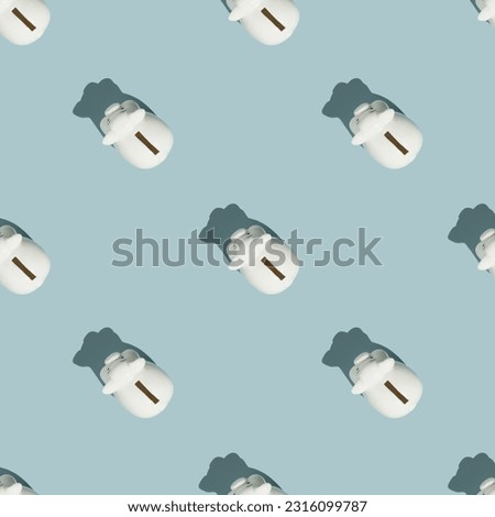 White piggy banks on blue background. Financial and money saving pattern concept flat lay