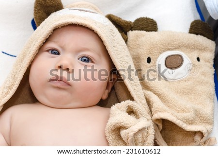 baby wrapped in a towel brown