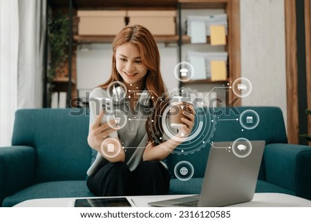 Woman using smart phone for mobile payments online shopping,omni channel,sitting on table,virtual icons graphics interface screen  Royalty-Free Stock Photo #2316120585