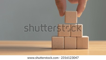 Businessman putting empty wooden cube on table, empty wooden cube for data entry and infographic icons