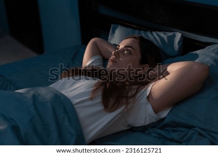 Sleep disorder, insomnia. Young woman lying on the bed awake at late night. Can not sleep Royalty-Free Stock Photo #2316125721