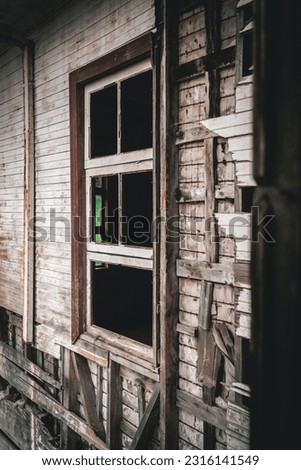 Time-worn wooden window in a weathered, ancient house. Layers of history etched in its grain, offering a glimpse into the past and evoking a sense of nostalgia.