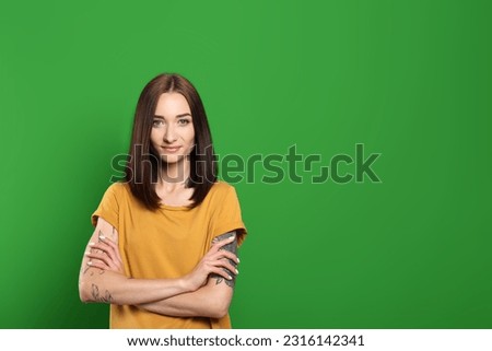 Chroma key compositing. Beautiful young woman against green screen